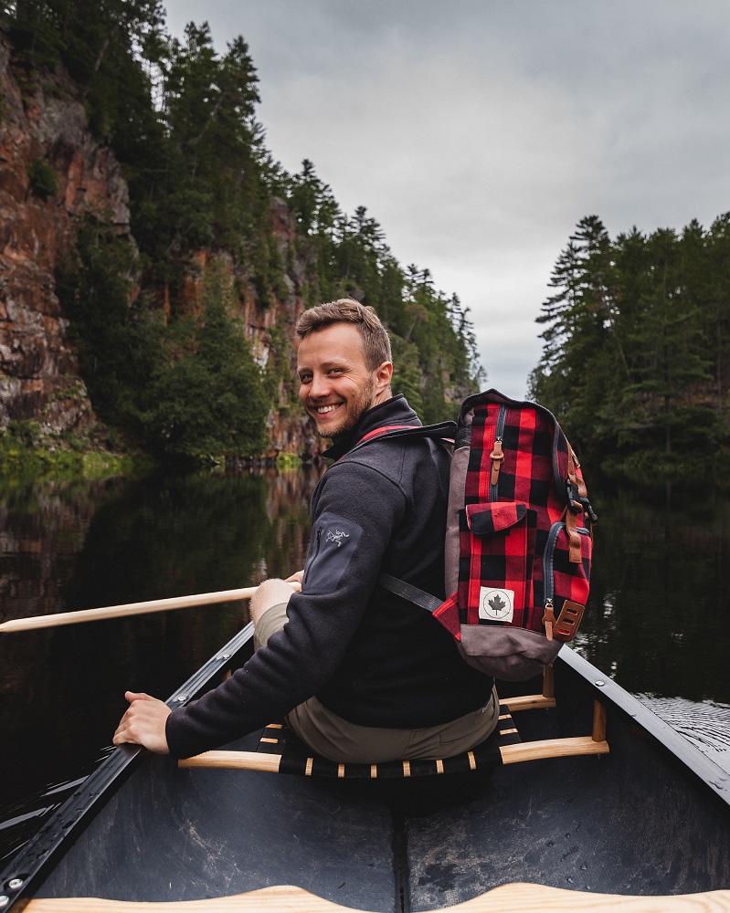 michael-frymus-wearing-red-backpack-on-canoe-at-algonquin-barron-canyon-1000